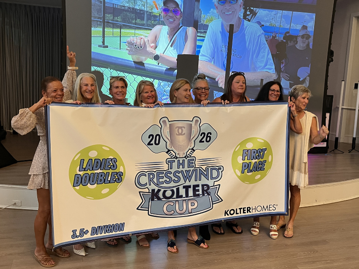 Ladies' Doubles 3.5+ first-place winners holding the 2026 Cresswind Kolter Cup banner